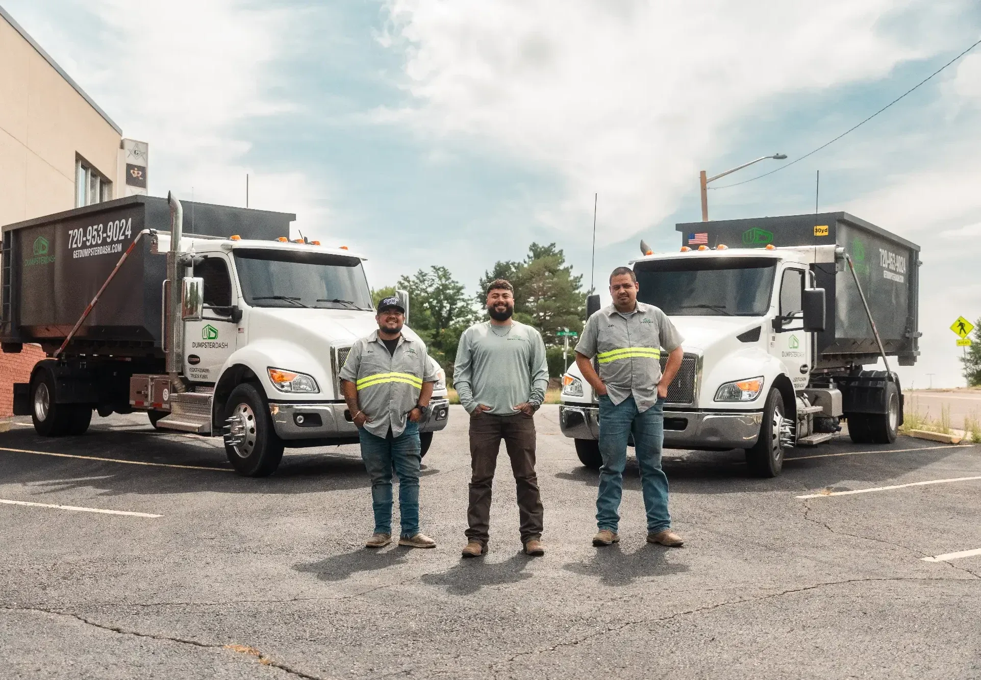 The DumpsterDash team with two roll-off trucks